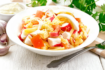 Image showing Salad of surimi and tomatoes with eggs on light board