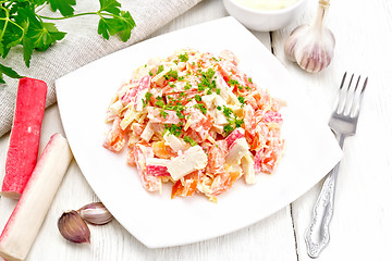 Image showing Salad of surimi and tomatoes with mayonnaise on board