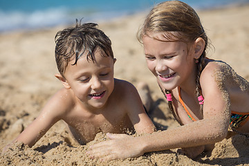 Image showing Happy children playing on the beach at the day time.