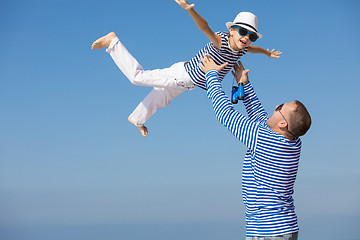 Image showing Father and son playing on the beach at the day time.