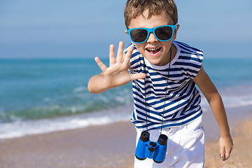 Image showing One happy little boy playing on the beach at the day time.