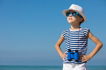 Image showing One happy little boy playing on the beach at the day time.