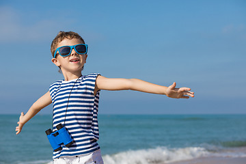 Image showing One happy little boy playing on the beach at the day time.