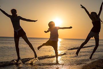 Image showing Happy children playing on the beach at the sunset time.