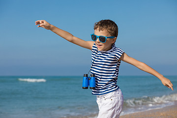 Image showing One happy little boy playing on the beach at the day time.