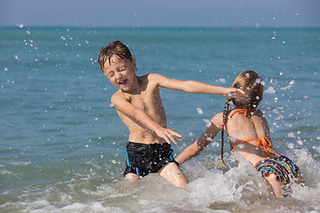 Image showing Happy children playing on the beach at the day time.