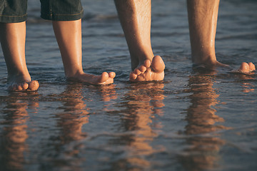 Image showing Father and son playing on the beach at the day time.