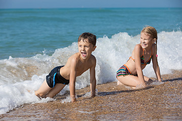 Image showing Happy children playing on the beach at the day time. 