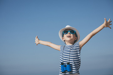 Image showing One happy little boy playing on the beach at the day time. 