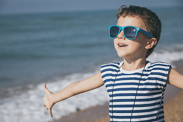 Image showing One happy little boy playing on the beach at the day time.