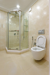 Image showing Bright bathroom interior with glass shower and toilet