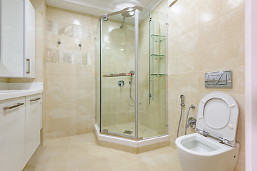 Image showing Bright bathroom interior with glass shower and toilet