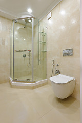 Image showing Bright bathroom interior with glass shower and toilet