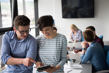 Image showing Two Business People Working With Tablet in office