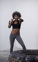 Image showing black woman workout with hammer and tractor tire