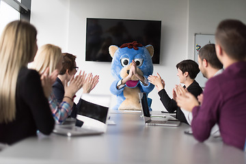 Image showing boss dresed as bear having fun with business people in trendy of