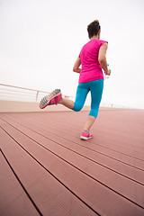 Image showing woman busy running on the promenade