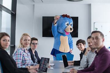 Image showing boss dresed as bear having fun with business people in trendy of