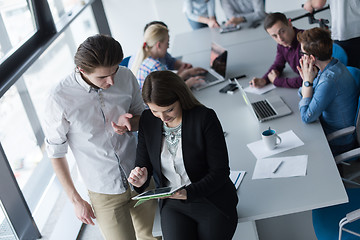 Image showing Two Business People Working With Tablet in office