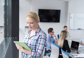 Image showing Pretty Businesswoman Using Tablet In Office Building by window