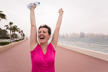 Image showing young woman celebrating a successful training run