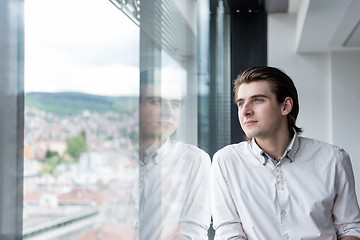 Image showing young businessman in startup office by the window