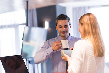 Image showing A young couple is preparing for a job and using a laptop