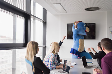 Image showing boss dresed as bear having fun with business people in trendy of