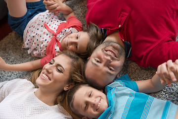 Image showing happy family lying on the floor