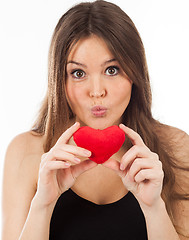 Image showing young woman in love with a heart in hand