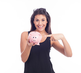 Image showing Young woman with glasses happy with piggy bank