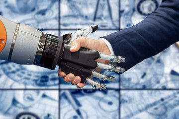 Image showing Hand of a businessman shaking hands with a Android robot.