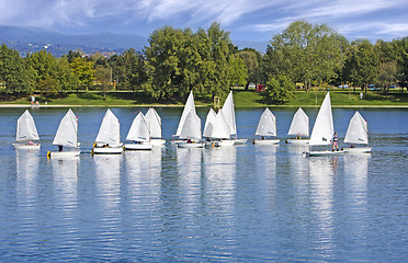 Image showing The small sailing ships regatta on the blue lake