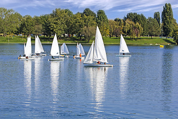 Image showing The small sailing ships regatta on the blue lake