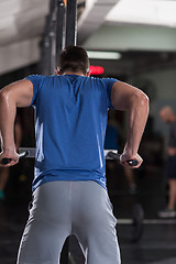 Image showing man doing exercises parallel bars