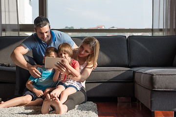 Image showing happy young couple spending time with kids