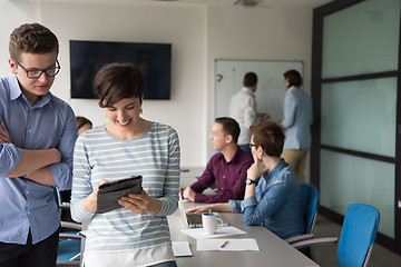 Image showing Two Business People Working With Tablet in office