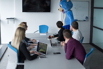 Image showing boss dresed as bear having fun with business people in trendy of