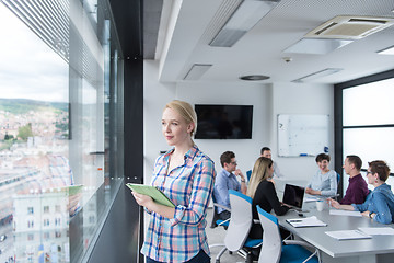 Image showing Pretty Businesswoman Using Tablet In Office Building by window