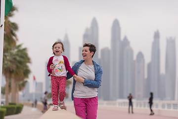 Image showing mother and cute little girl on the promenade