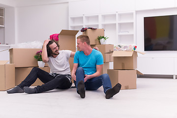 Image showing young  gay couple moving  in new house