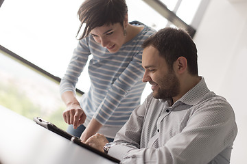 Image showing Two Business People Working With Tablet in startup office