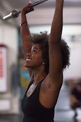 Image showing black woman lifting empty bar