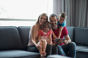 Image showing happy young couple spending time with kids