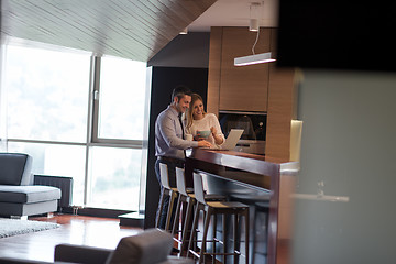 Image showing A young couple is preparing for a job and using a laptop