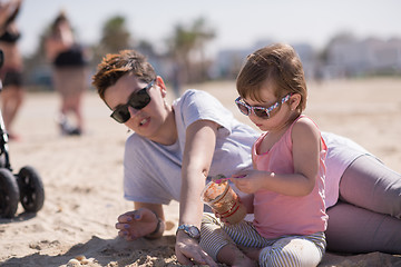Image showing Mom and daughter on the beach