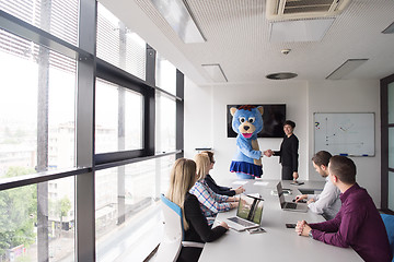 Image showing boss dresed as bear having fun with business people in trendy of