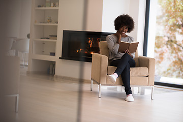 Image showing black woman at home reading book