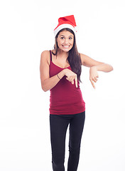 Image showing Happy christmas woman pointing
