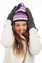 Image showing Face of pretty woman with gloves and knitted winter cap  with smile